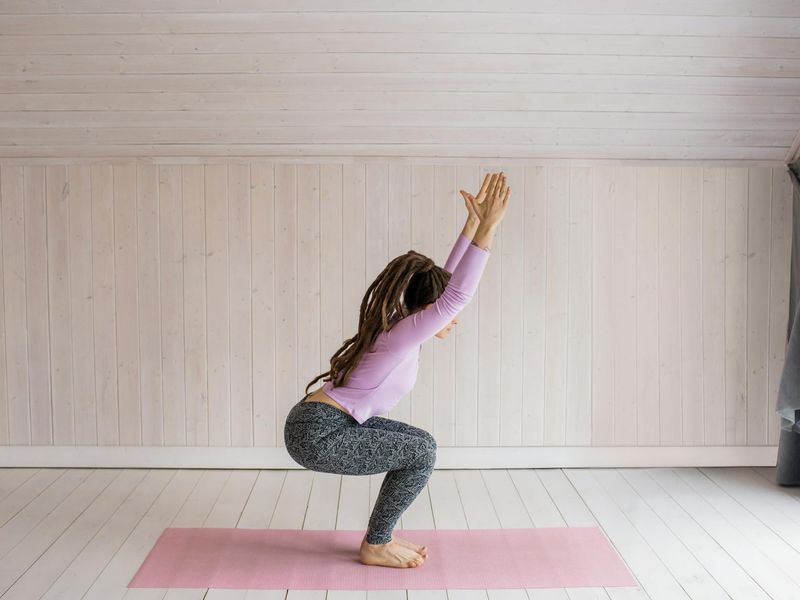 Person practicing yoga in a bright modern studio room
