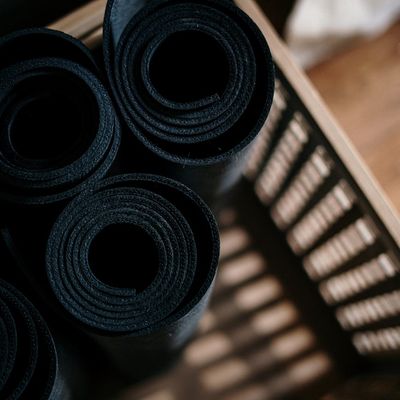 Roll of yoga mats in a design basket