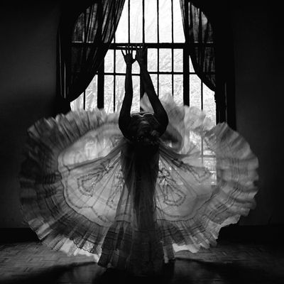 Silhouette of person in balance pose against window